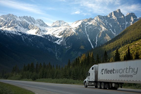 white-truck-near-pine-tress-during-daytime-hi-res-color-logo
